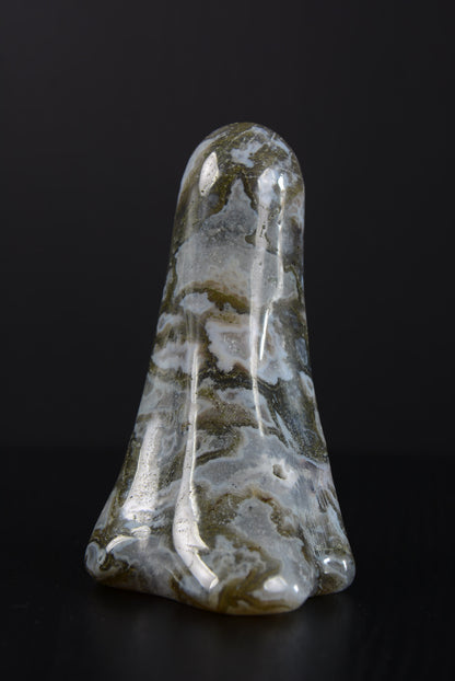 Rear view of a polished ghost ornament, displaying the smooth and finely polished backside, with natural stone textures and unique color gradients, showcasing the skilled artistry and the ghost’s serene, timeless grace.